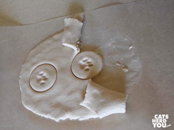 peeling clay away from paw print keepsakes